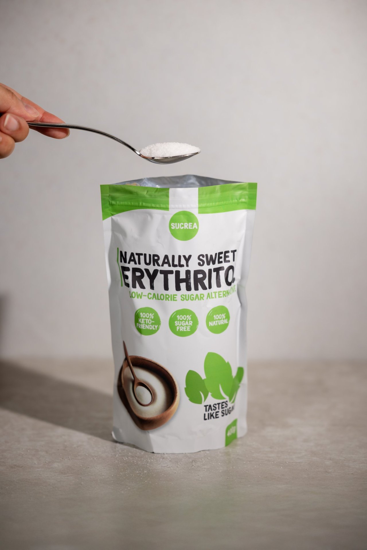 A spoonful of Sucrea above the pouch